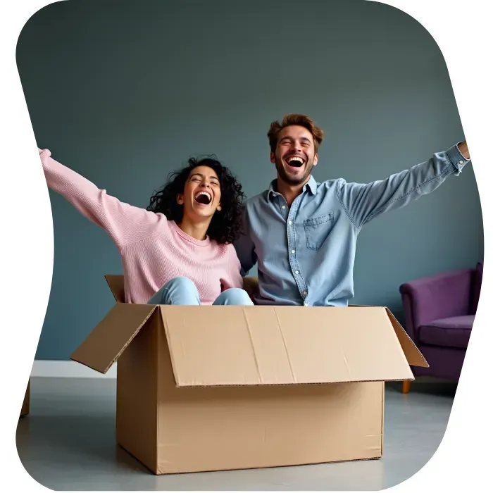 Two guys sitting on the floor of their apartment with Muval moving boxes